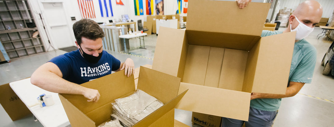 Box it up: Staff members help sort and pack thousands of clothes